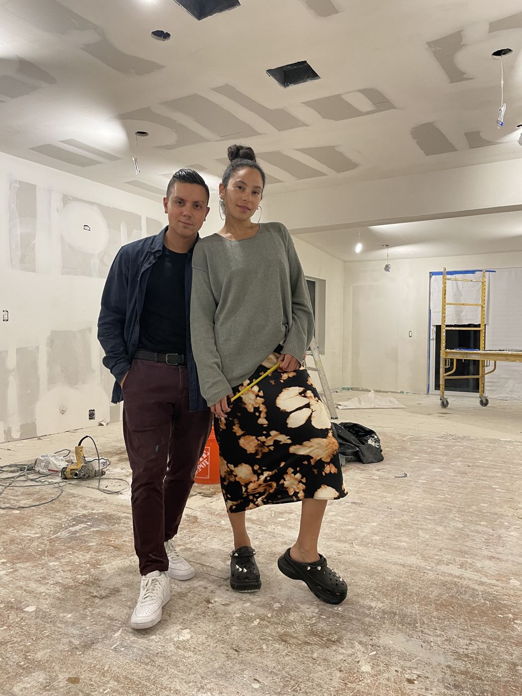 William and Luiza standing inside a Miami house mid-renovation